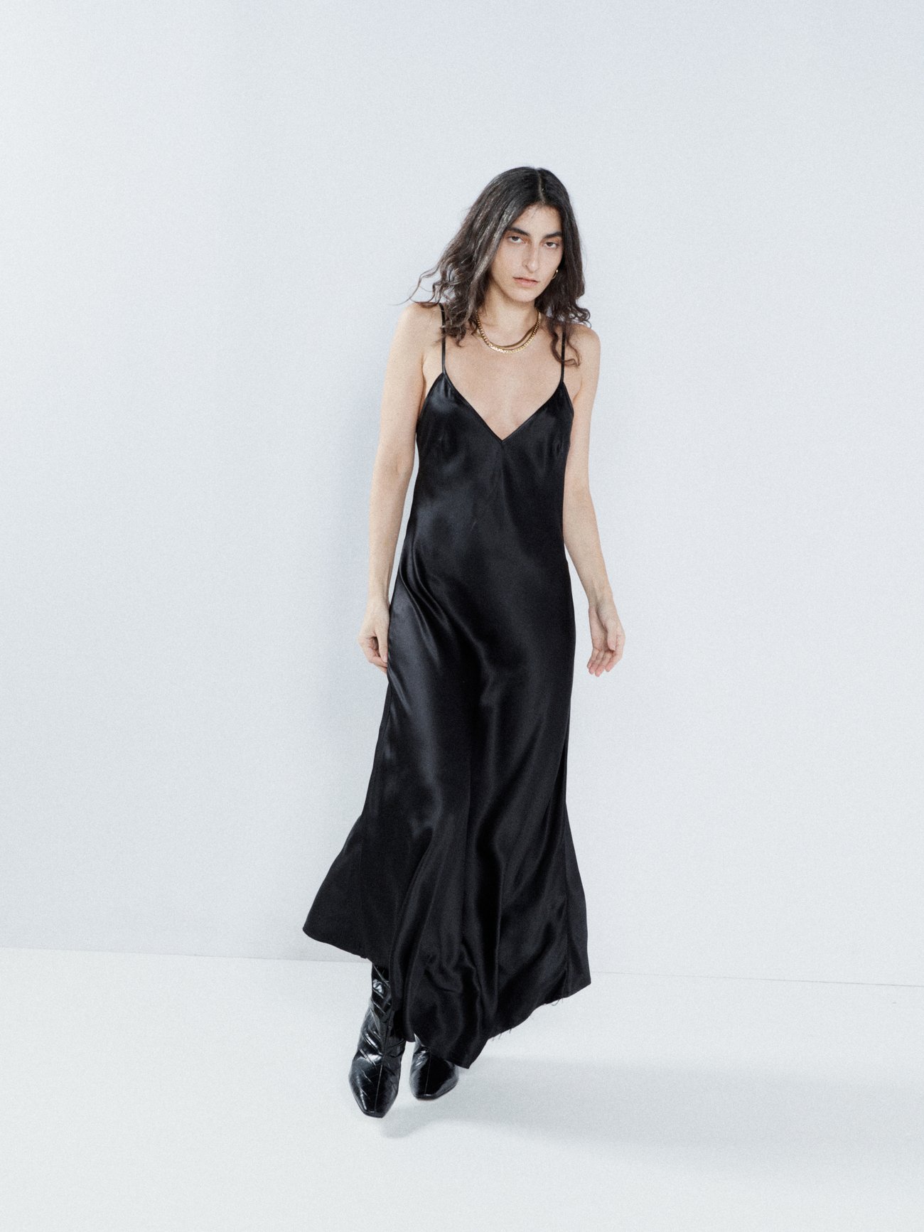 Raey’s black slip dress captures the label’s pared-back, understated aesthetic. It’s made in the UK from lightweight silk satin with a V-neck and a raw-edged asymmetric hem.
Shown here with: Jil Sander Padded-strap leather flatform slides