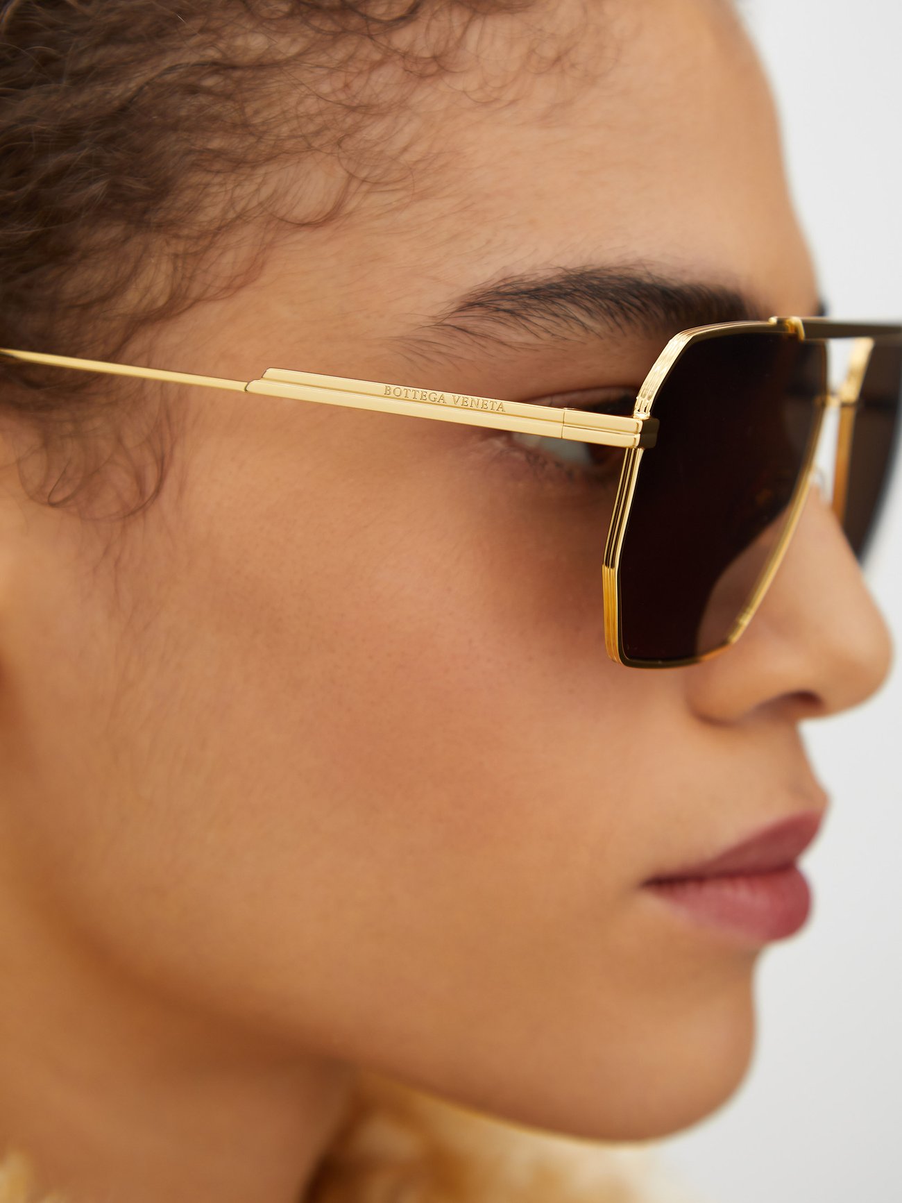 Bottega Veneta® Bond Metal Aviator Sunglasses in Gold. Shop online now.