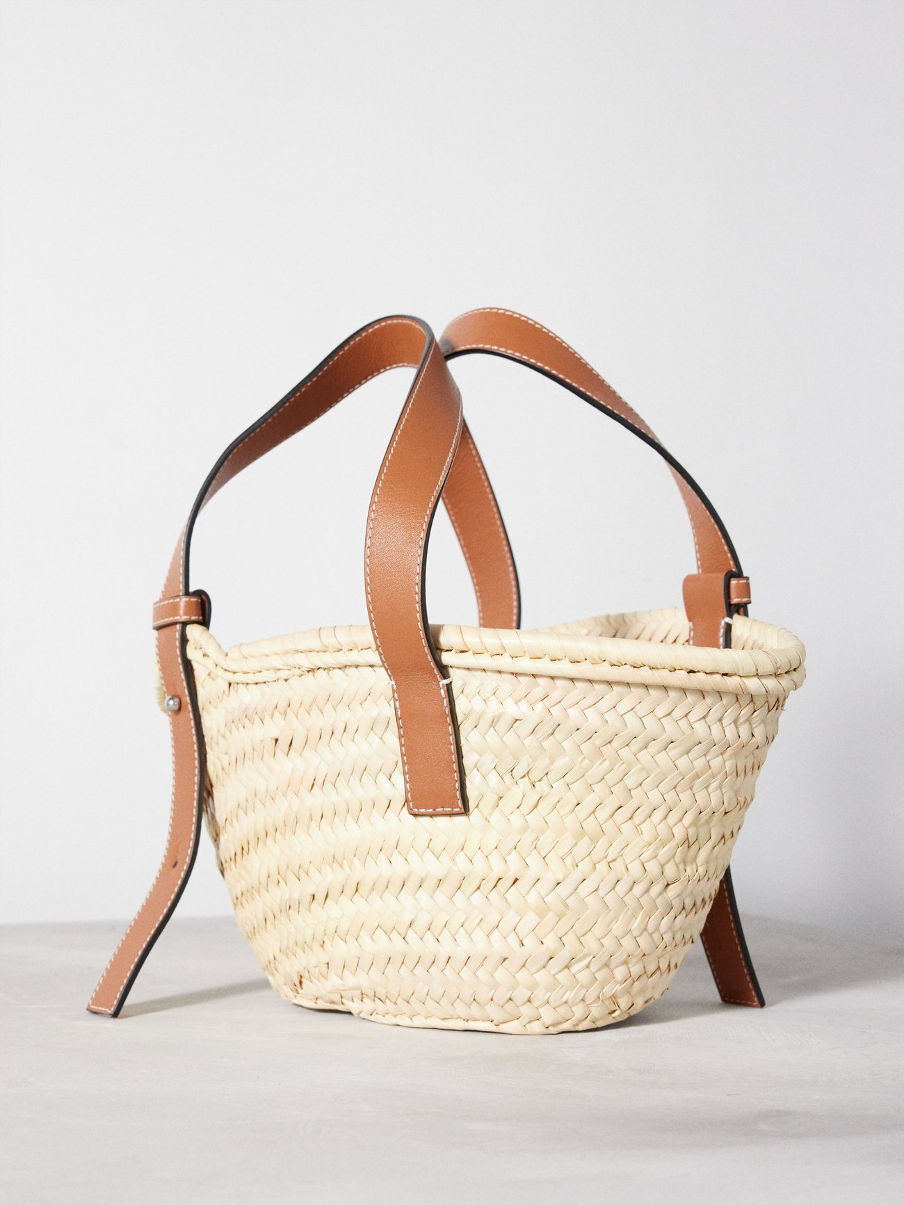 Anagram small leather-trimmed woven basket bag