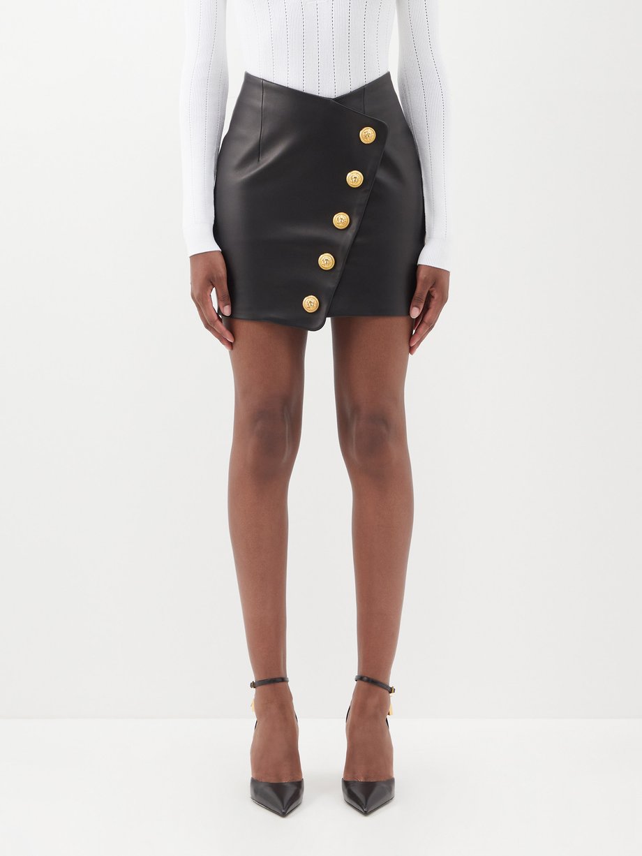Black Asymmetric buttoned leather mini skirt | Balmain | MATCHESFASHION UK