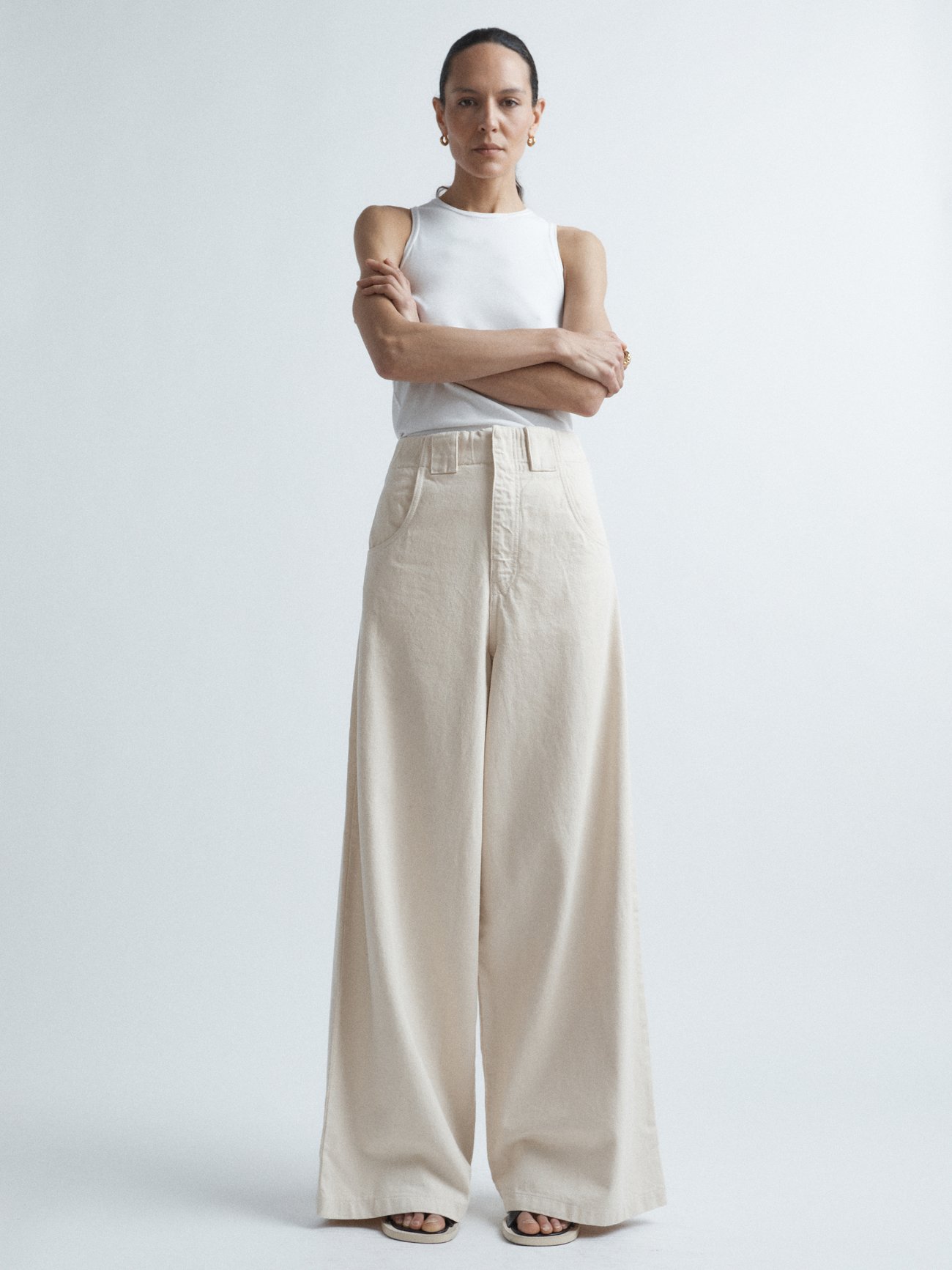 Raey's high-rise, wide-leg ivory denim jeans are made from organic cotton, which uses less water and chemicals during the fabric production process.
Shown here with: Raey Scoop-neck cotton-blend jersey vest and Maison Margiela Tabi 60mm split-toe leather slingback pumps