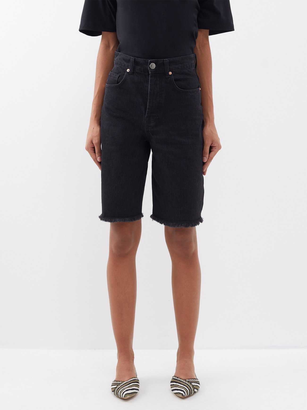 jorts trend 2024 - Raey’s longline black 90s denim shorts are made from mid-weight organic-cotton denim with a high-rise waist and five pockets, capturing the retro mood.