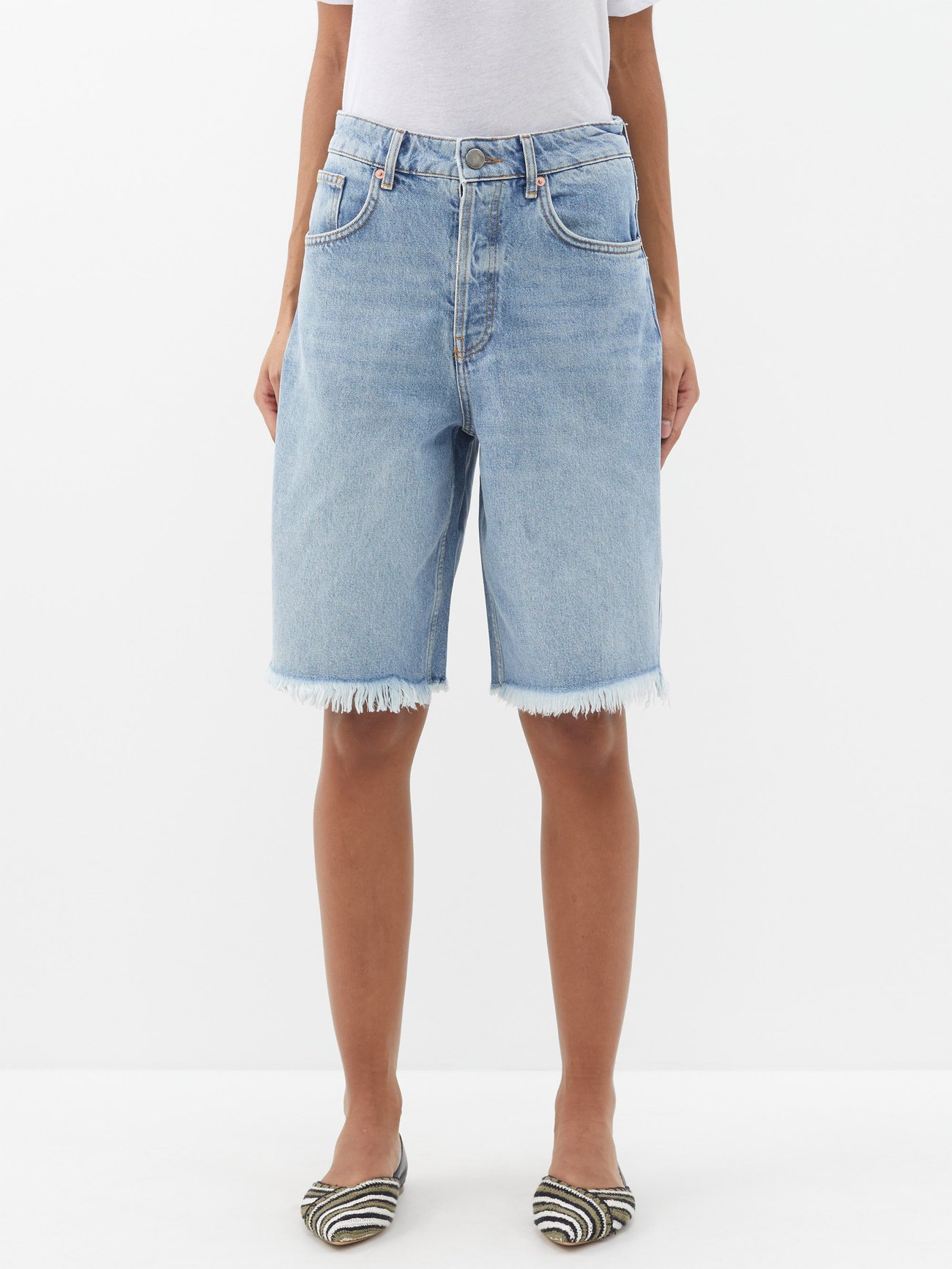 jorts trend 2024 - Raey models these light blue organic-denim shorts on 1990s shapes, reflected by the longline shape and raw-edge cuffs.