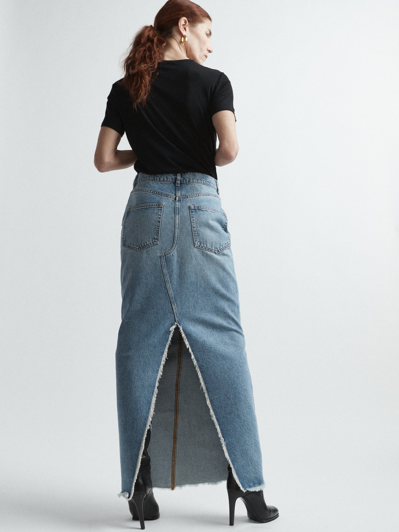 Cut from panels of washed organic denim, Raey's blue workwear-inspired maxi skirt is shaped with raw-hemmed edges and a back slit.