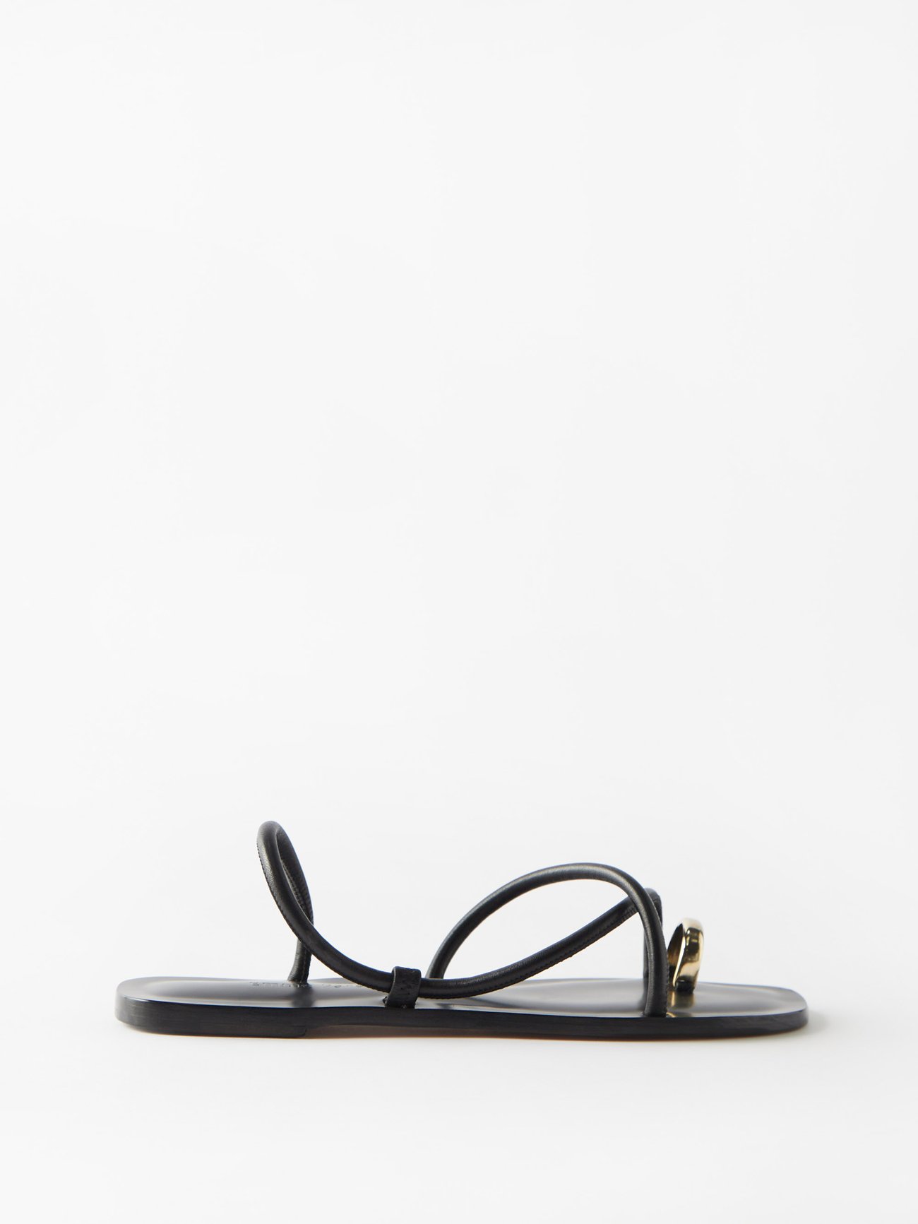 Emme Parsons' black Laurie sandals feature a striking gold toe-ring, a padded insole and thick leather straps designed to stretch over time, adapting to the wearer.