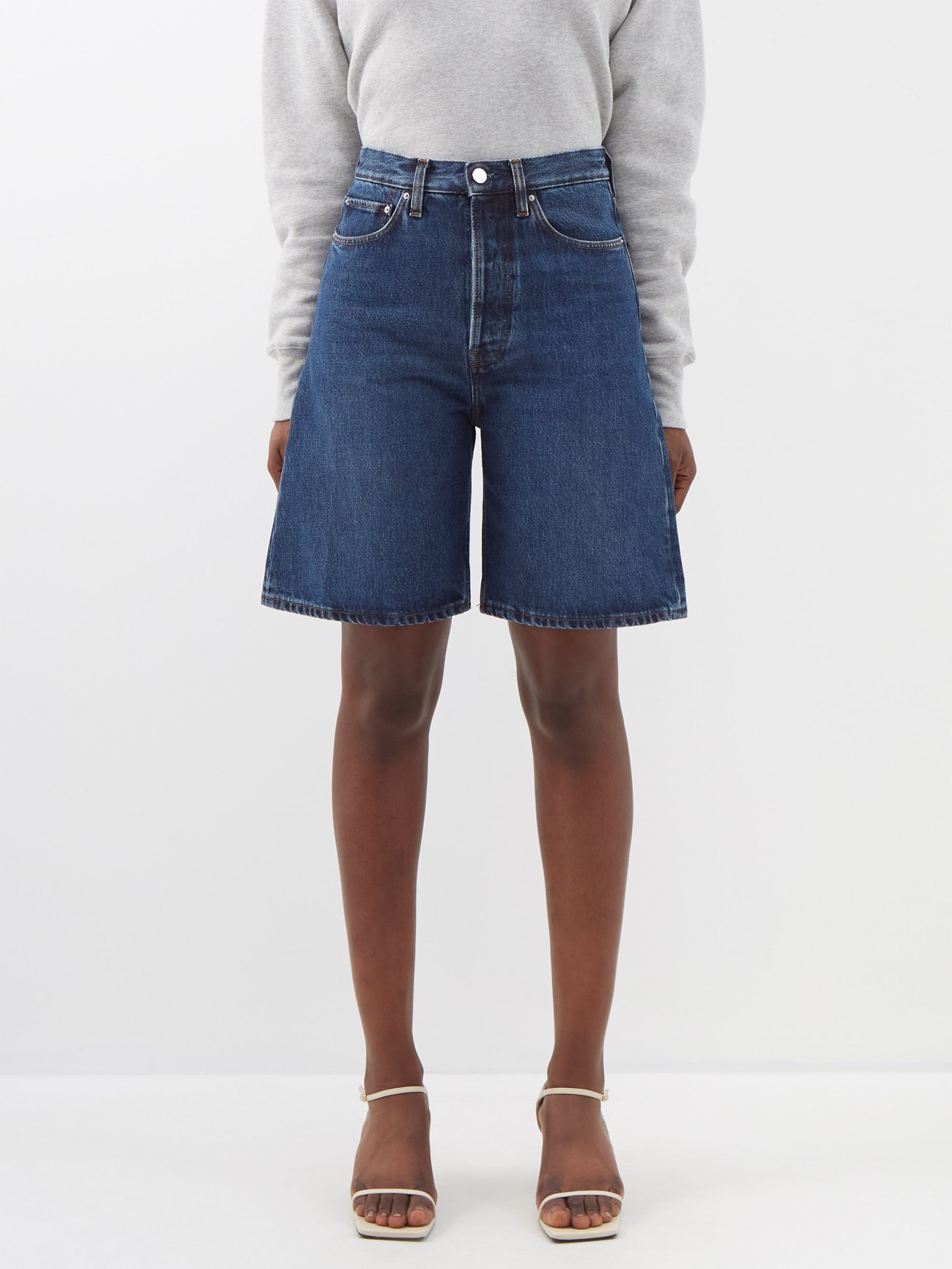 Toteme’s elevated take on the Bermuda short sees this blue high-rise version rendered in washed organic-cotton denim stamped with a leather logo patch.