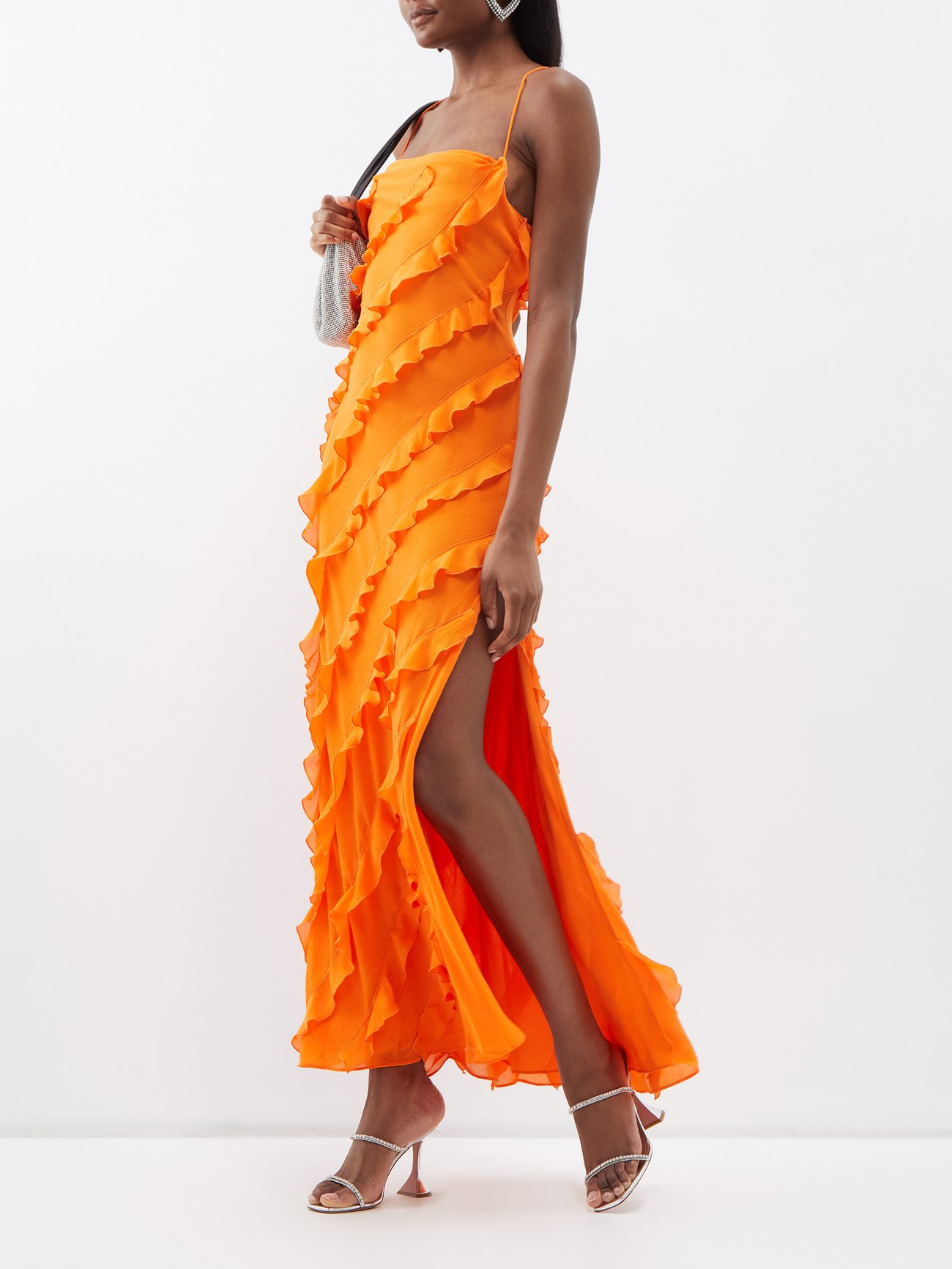 Spice up your summer party looks with Staud's orange Elvire dress. Shaped to a figure-skimming slip from lightweight crepe with diagonal ruffles, an open lace-up back and a thigh-high slit.