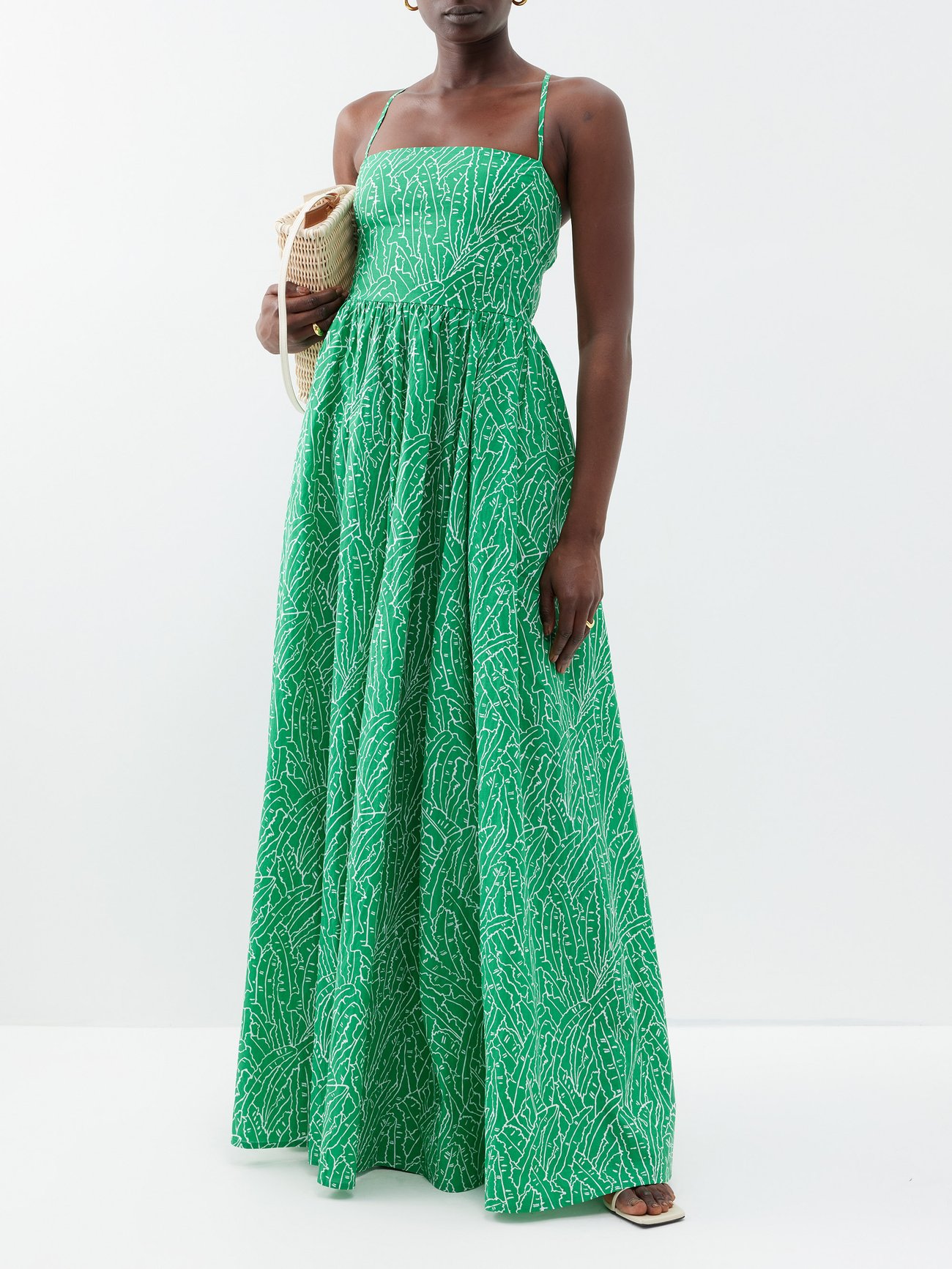 Dyed a verdant shade of green, Staud's square-neck cotton Courtney maxi dress is saturated with a warm weather-inspired palm leaf print.