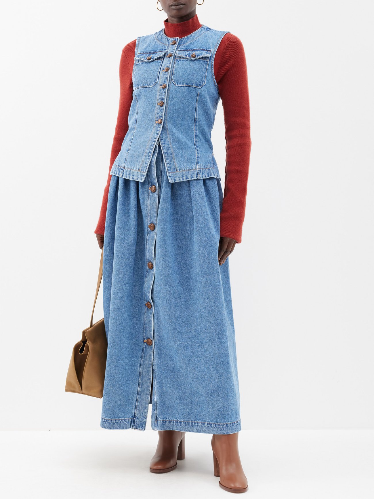 Artisans in Giuliva Heritage's Roman workshop spend six hours handcrafting this blue denim The Lilium skirt, punctuated with a gathered waist and woven leather buttons.