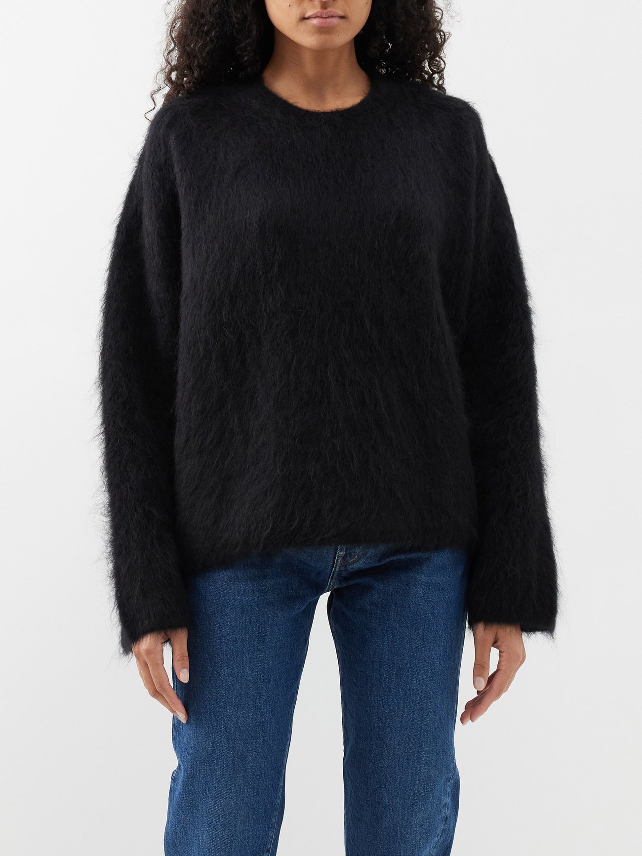 Toteme's black sweater is crafted from an alpaca blend that is lightweight and hairy to the touch and has dropped shoulders and a straight hem for a relaxed look.