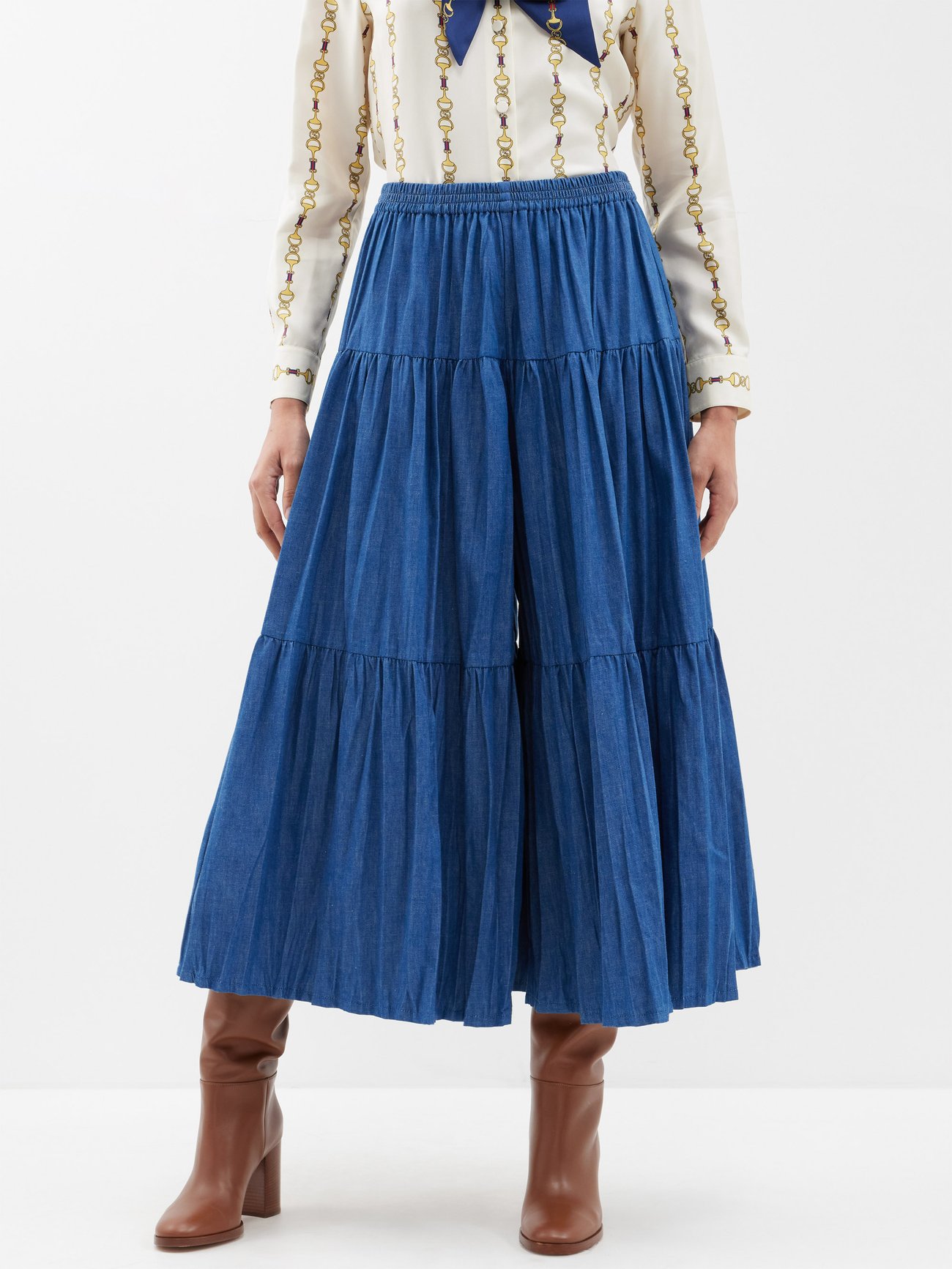 Gucci's blue banded skirt is made from washed cotton denim with banded panels, accented with gold logo-embossed buttons down one side.