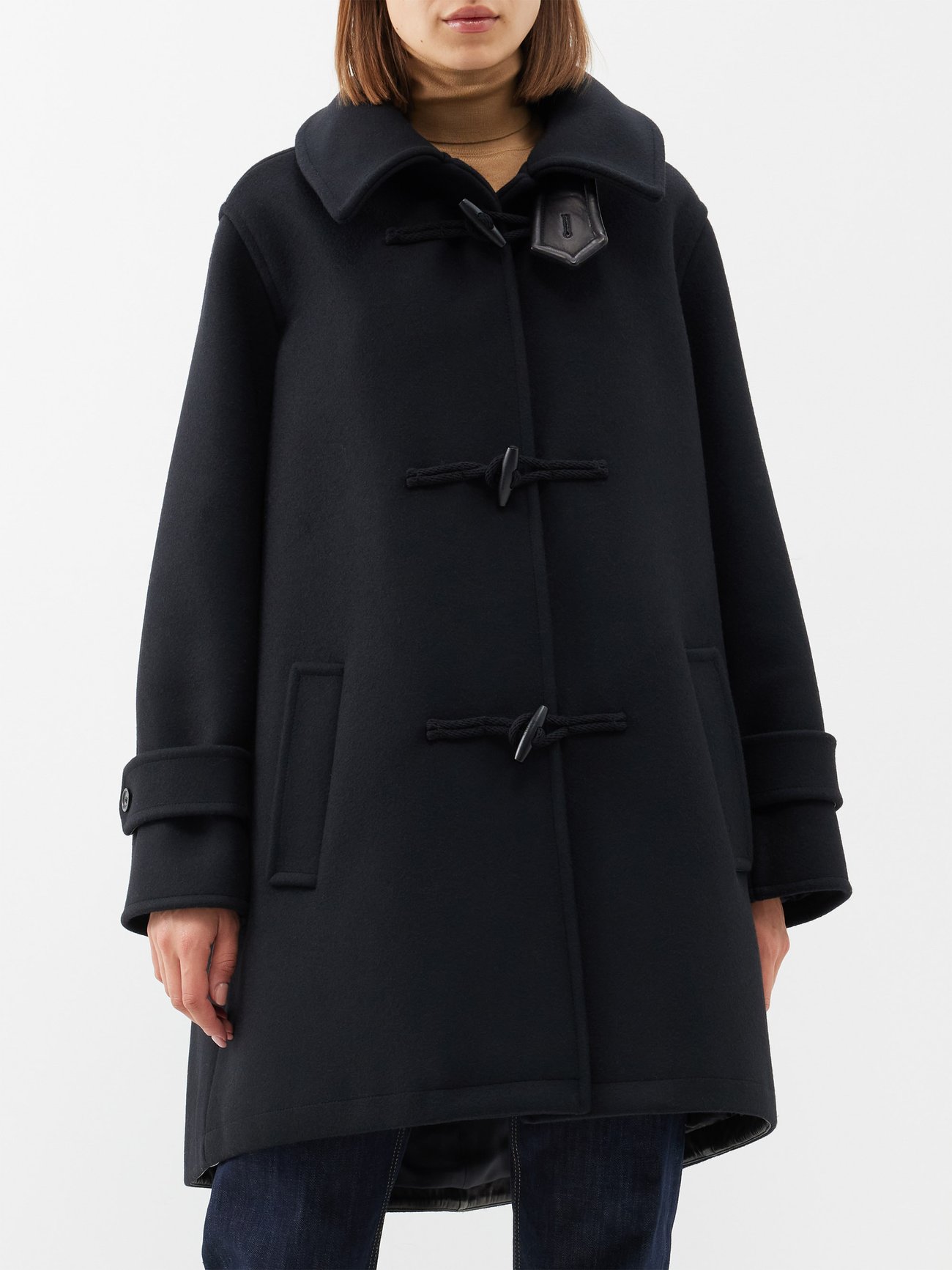 Trending Winter Coats 2023 2024 - Saint Laurent's black duffle coat is crafted from a durable wool and reworks the silhouette with a contemporary exaggerated collar and large toggles.
