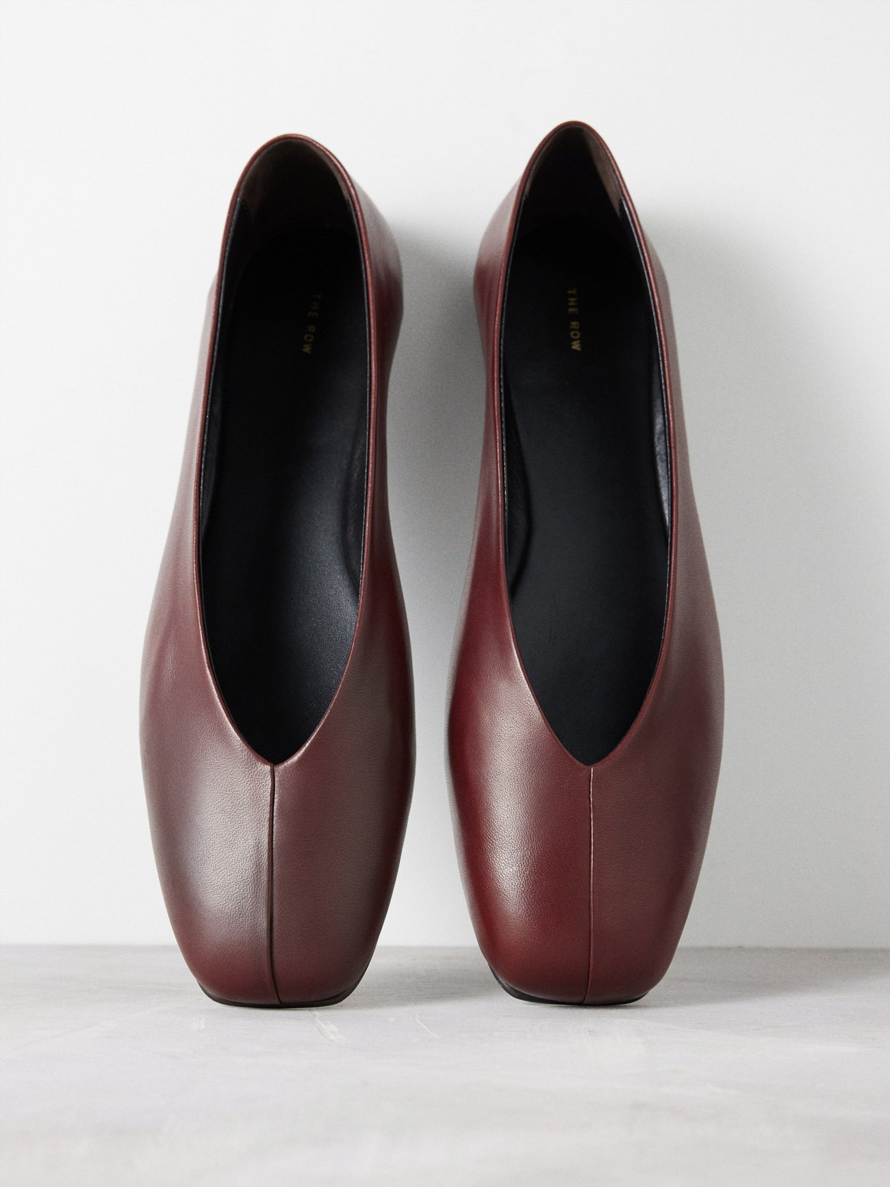 This sublime iteration of The Row’s Eva Two pumps consists of dual burgundy lambskin panels converging at the centre, set above a slender calf leather sole.