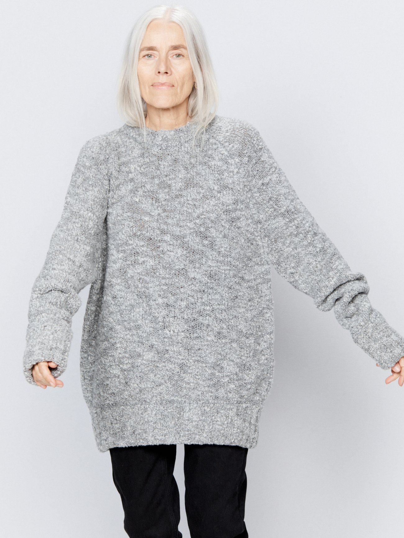 Made from a textured bouclé knit, Raey’s grey-marl sweater is designed with a classic crew neck and long raglan sleeves, hemmed by wide ribbed edges.