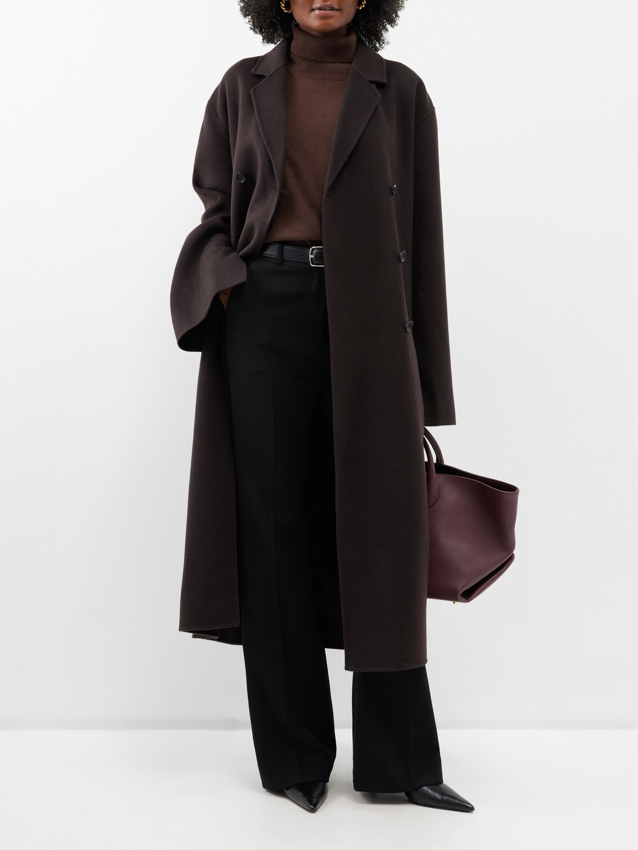 Toteme's dark brown Signature coat is tailored to a menswear-inspired silhouette from pressed RWS-certified wool with a slightly oversized double-breasted frame.