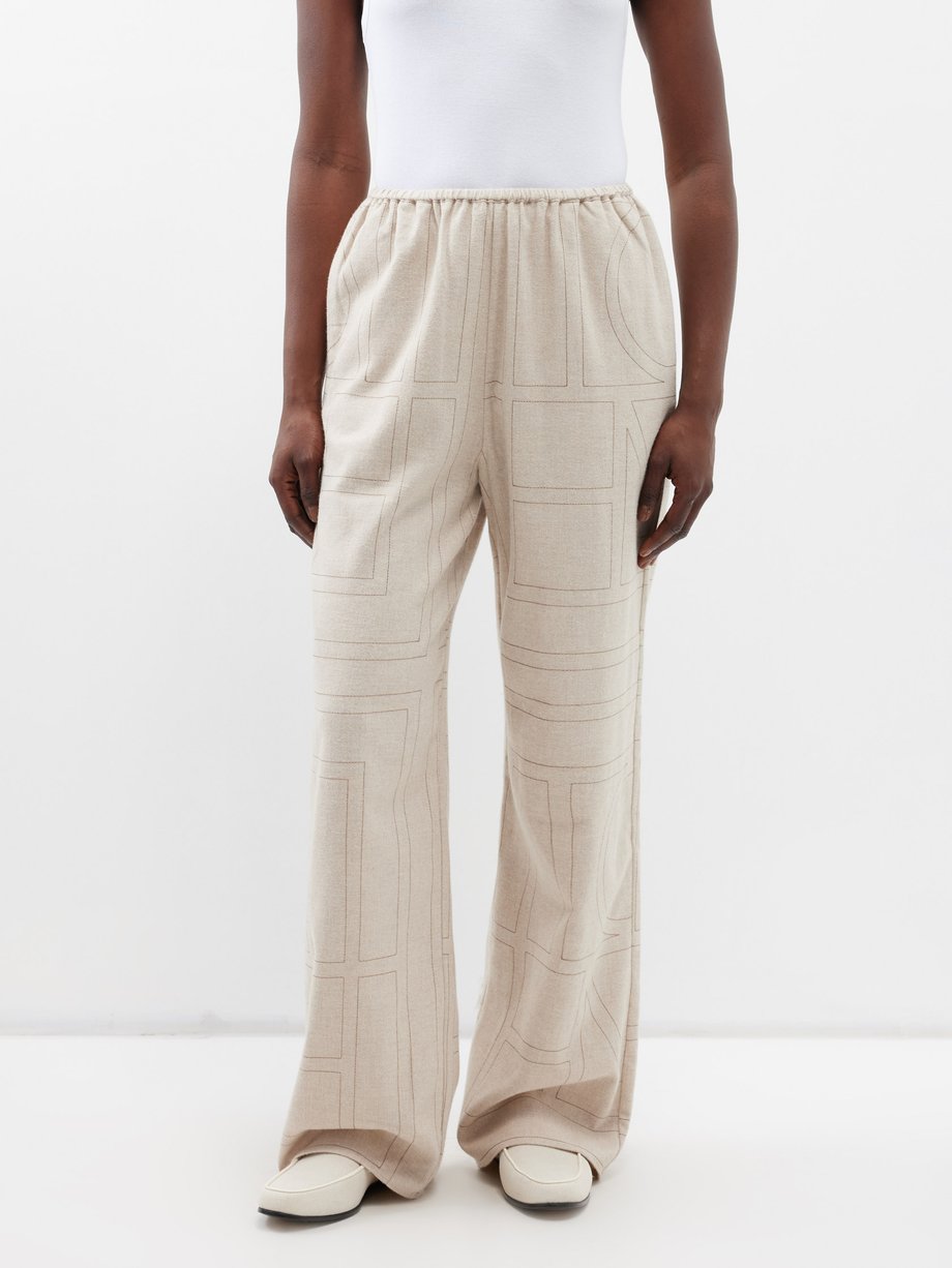 Beige Monogram-embroidered modal-flannel trousers | Toteme | MATCHES UK