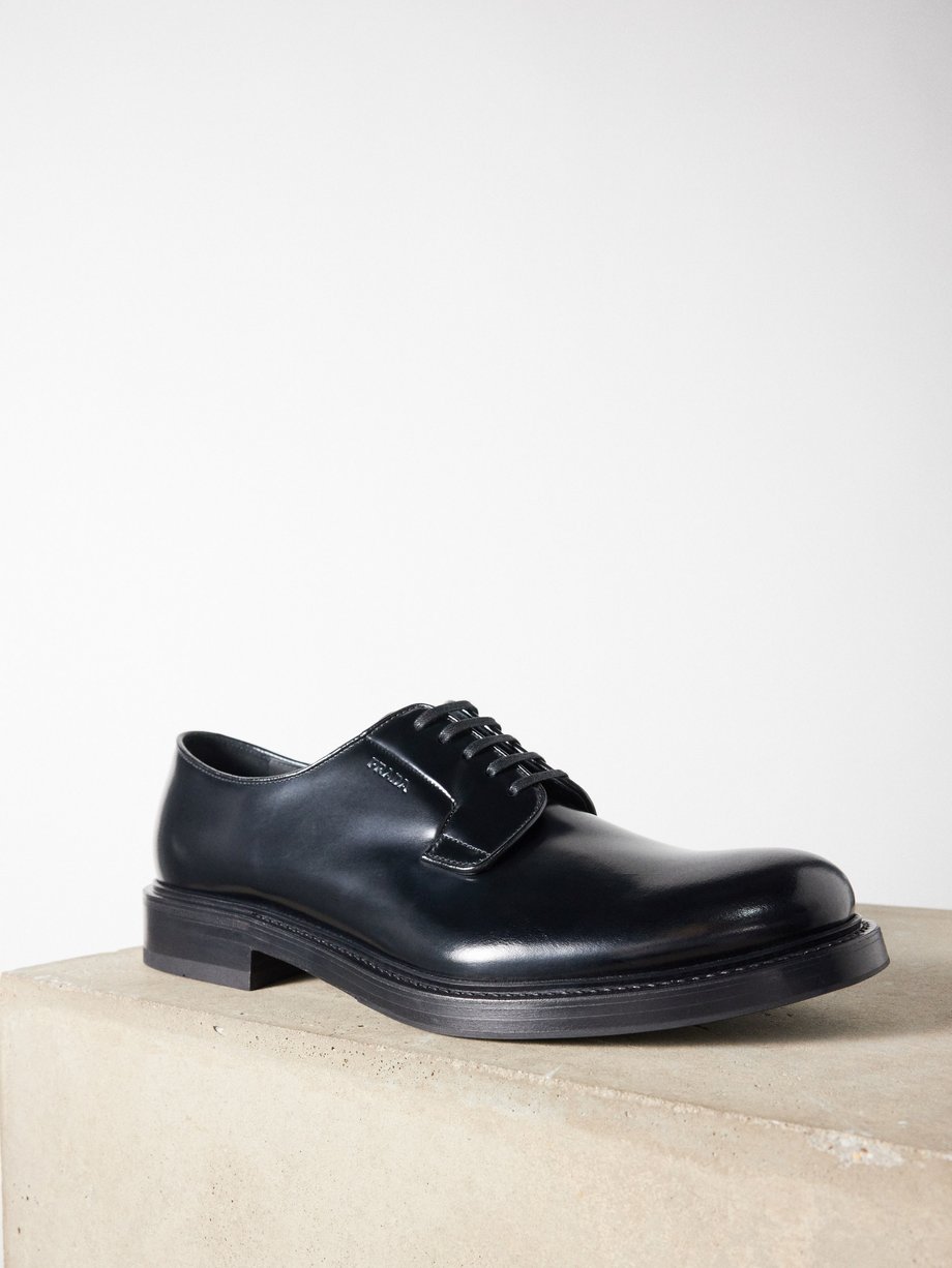 Black Logo-debossed leather Derby shoes | Prada | MATCHES UK