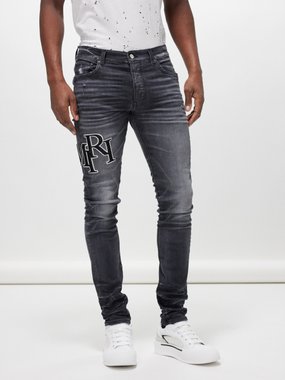 Amiri Staggered Logo distressed skinny-leg jeans