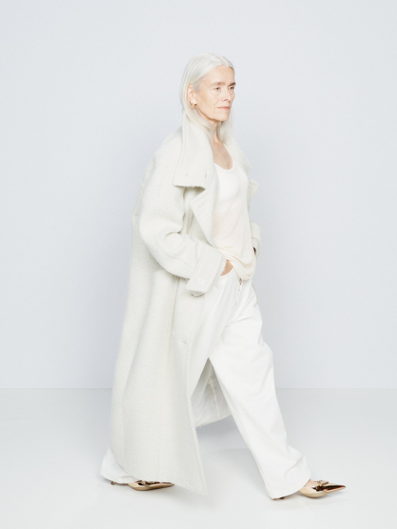 Raey's ivory coat is made to a generous double-breasted silhouette from a textured wool blend, with buttoned cuff tabs and a self-tie belt.
