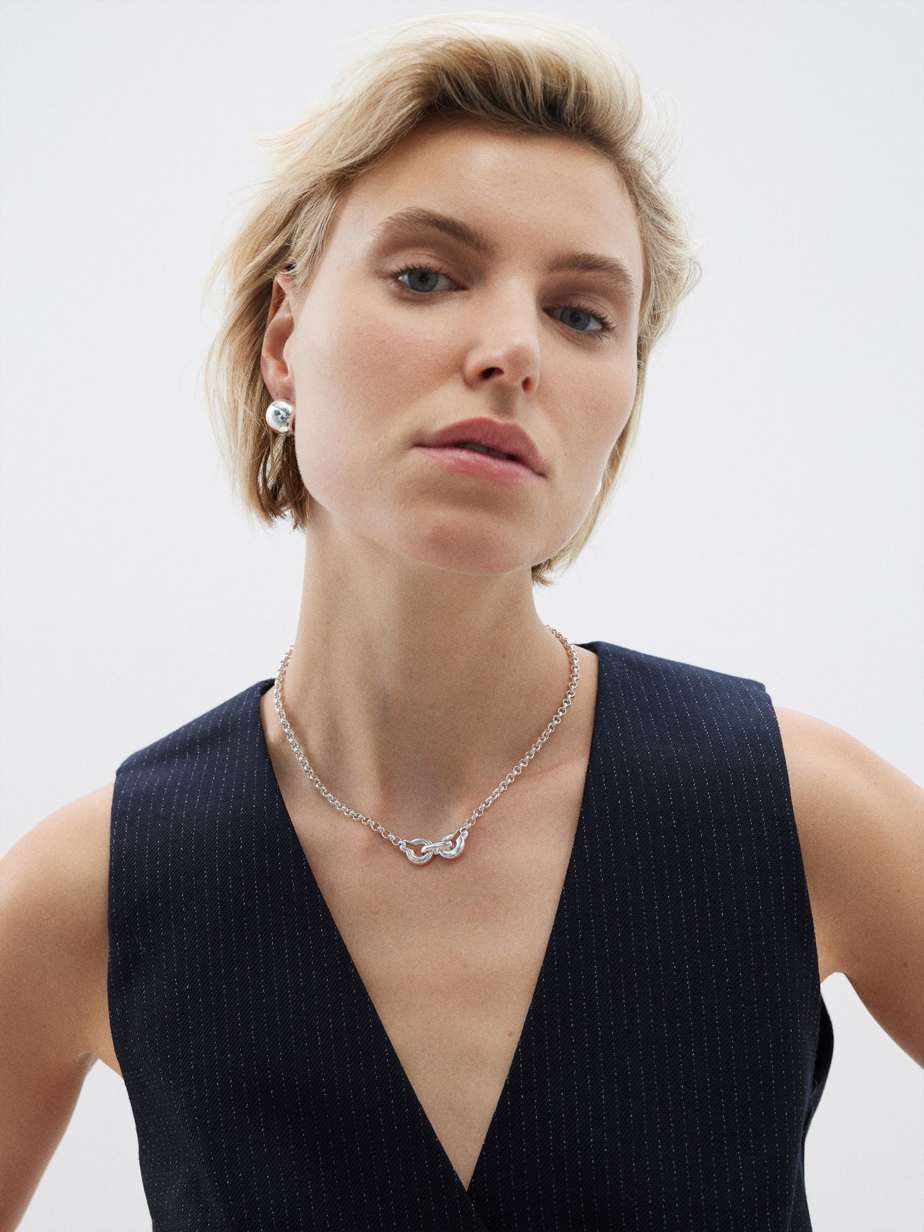 Chain and pendant mirror one another in Annika Inez's handmade sterling silver Ample Clasp necklace, shaped with rounded rolo links.