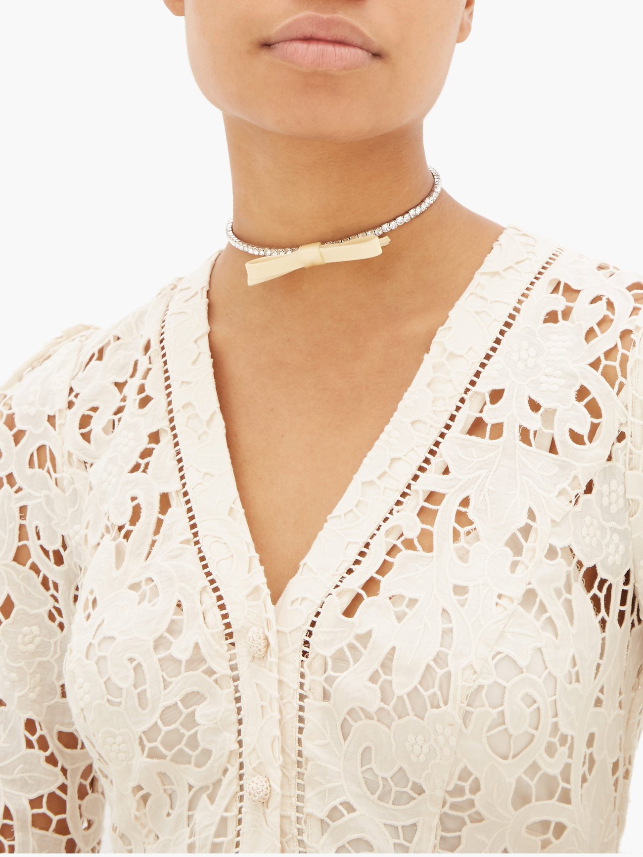 Miu Miu’s white choker necklace is adorned with a beige satin bow which echoes Miuccia Prada’s feminine sensibility. It’s crafted in Italy from silver-tone metal encrusted with sparkling pavé-set crystals around the coiling band. Frame it with the neckline of a lace dress for an elegant occasion look.