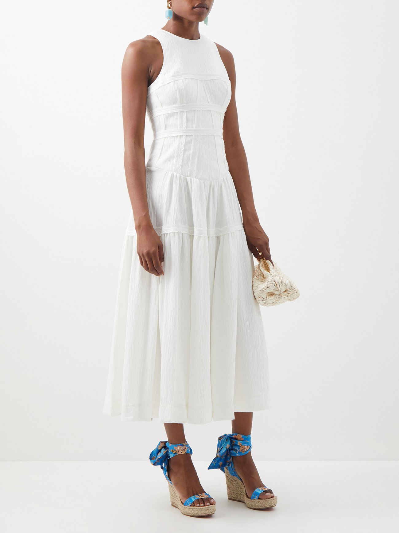 AJE's ivory Tidal dress is crafted from lightweight linen-blend voile accented with panelling at the bodice for a sculpting effect. It has wide straps, a round neck, and a loose-fit midi skirt. It has a Concealed back zip. 