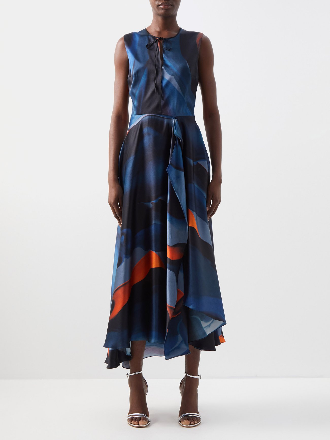 Roksanda Ilincic references her architectural studies for this blue Hamina midi dress, which is crafted from lustrous silk with a marble print and asymmetric hem. It has flashes of orange across the loose fit skirt. It's fitted at the waist and has a round neck with wide straps and a tie detail at the neck with the tiniest opening. 