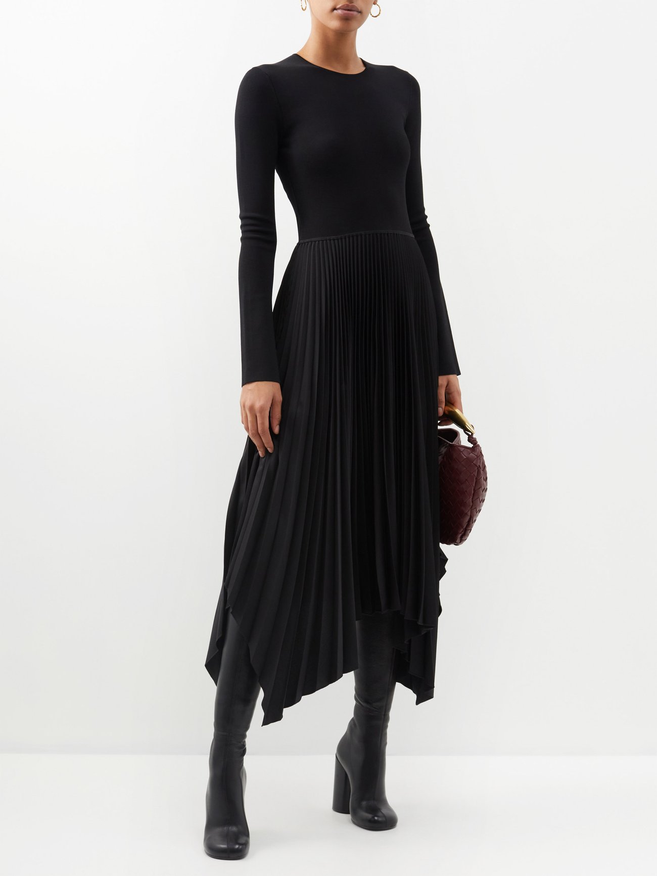 Joseph's black Deron midi dress is made from a technical smooth knit with elongated sleeves and an asymmetric pleated skirt that falls to a handkerchief hem.
