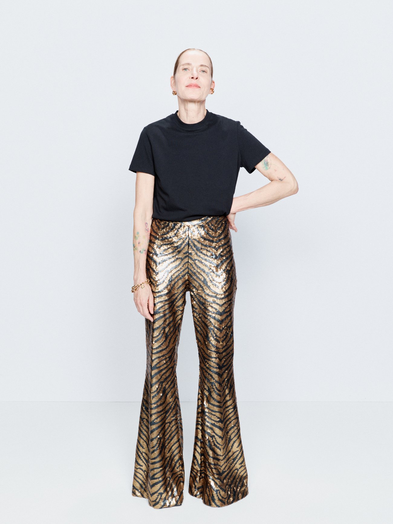 Raey enlivens the bootcut shape of these trousers by embellishing the flared legs with gold and black sequins, arranged to form a tiger stripe pattern.