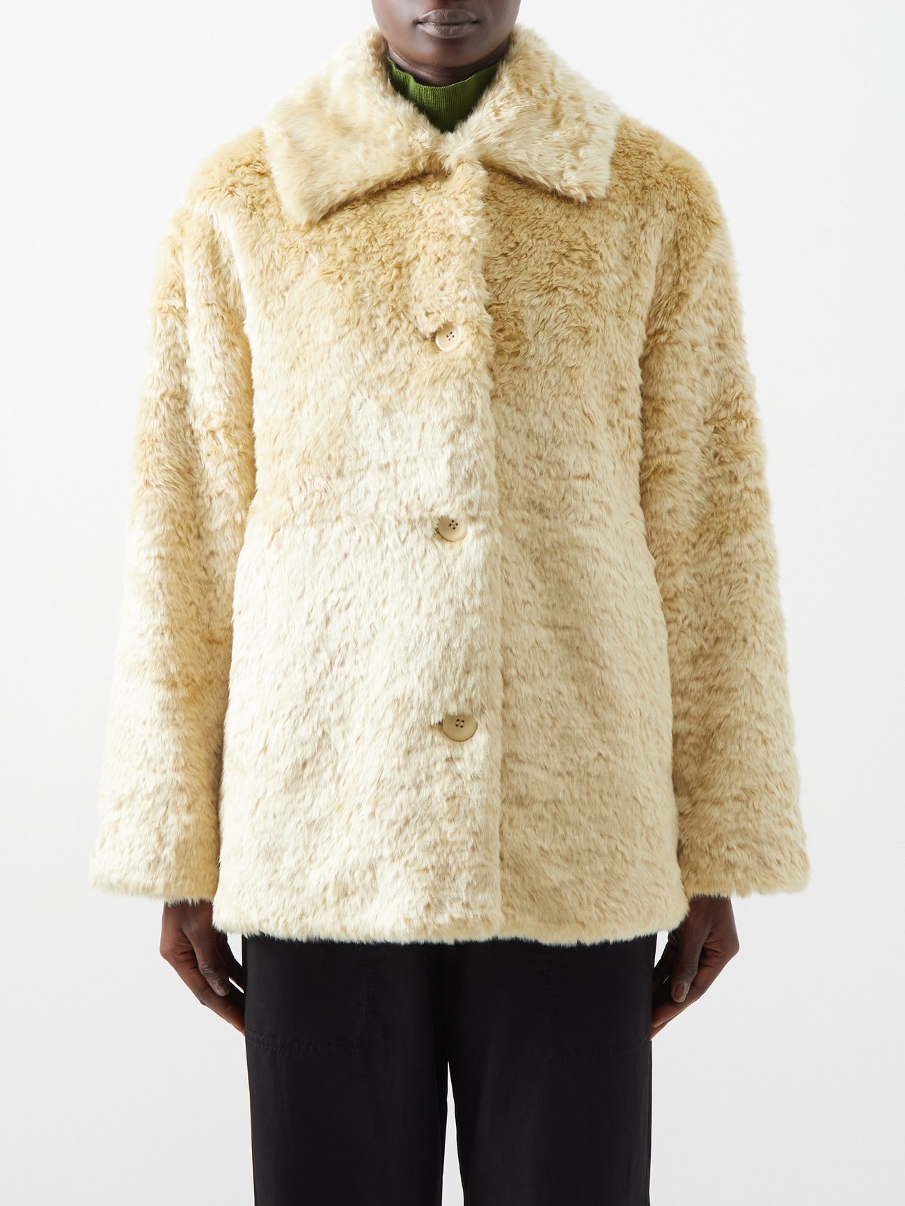 This eggshell-yellow coat by Proenza Schouler White Label is crafted from faux fur with a spread collar and button front for an elegant note.