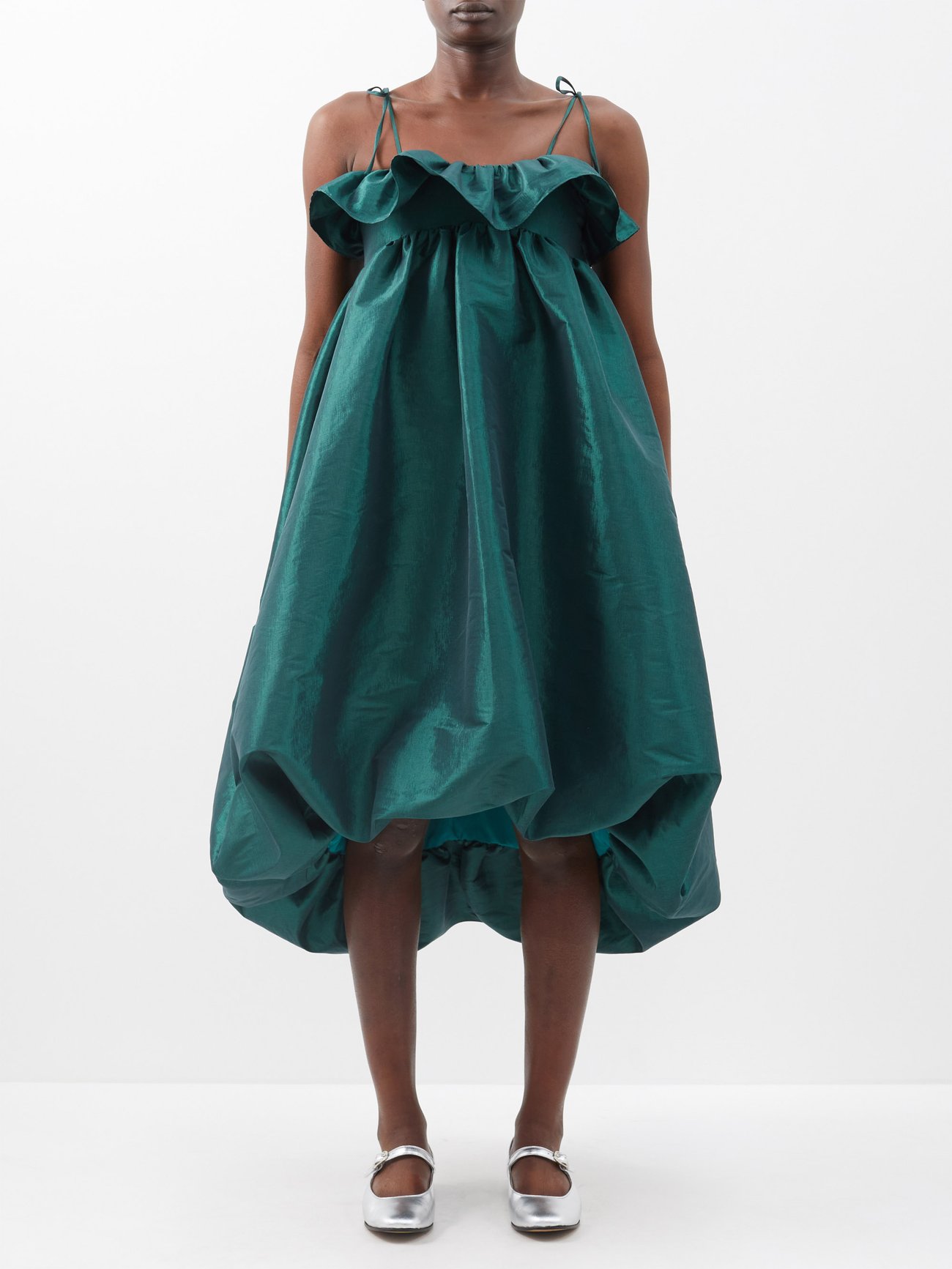 Kika Vargas borders this forest-green Resha midi dress with a ruffled neckline and cinched hem, echoing the Colombian designer’s focus on volume and proportion.