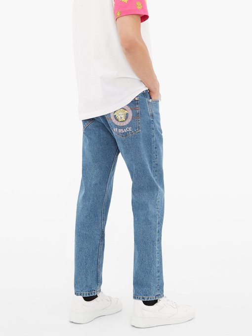Logo-embroidered denim jeans | Versace 