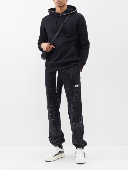 Amiri Cracked Dye Logo Sweatpants In Black | ModeSens