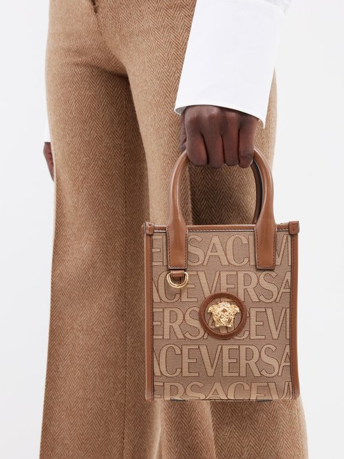 VERSACE: bag in canvas and embossed logo - Sand | Versace handbag 1005861  1A03494 online at