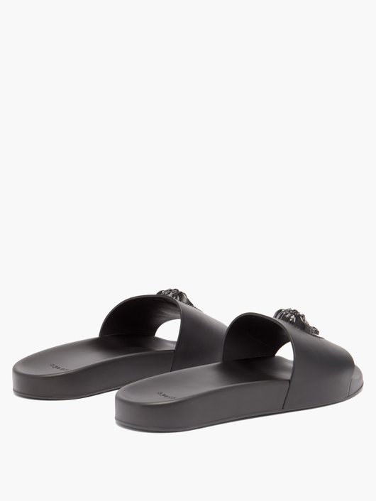 Medusa-embossed leather and rubber slides