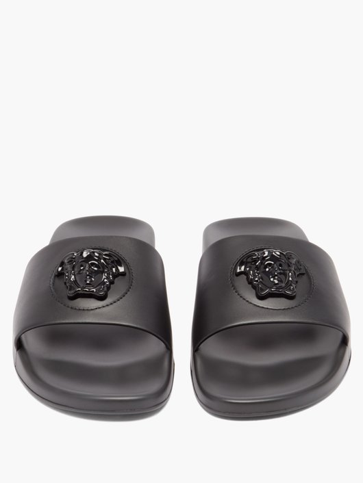 Medusa-embossed leather and rubber slides