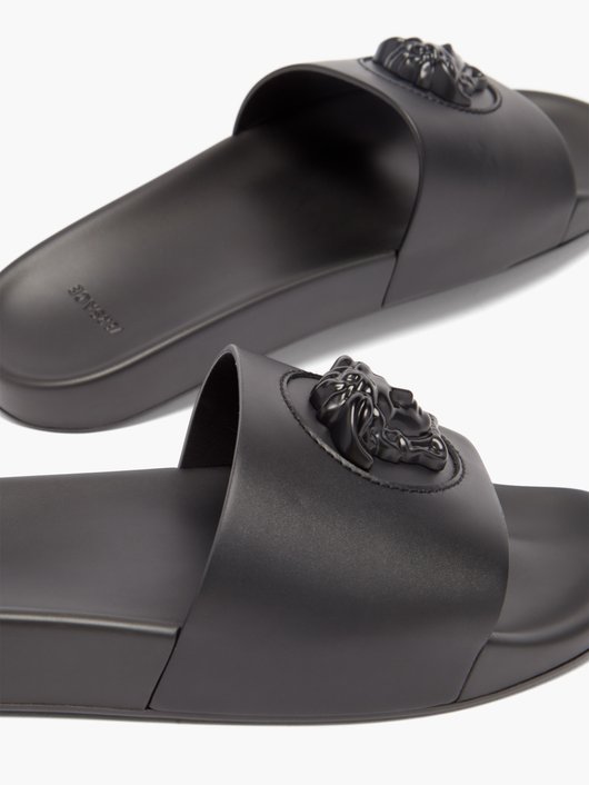 Medusa-embossed leather and rubber slides