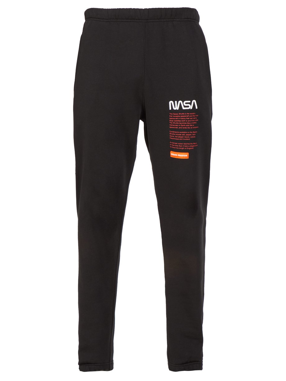 Black NASA-print track pants | Heron Preston | MATCHESFASHION US