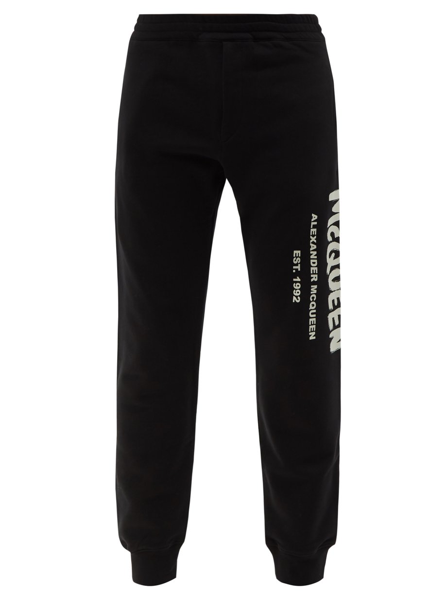 Graffiti logo-print cotton-jersey track pants Black Alexander McQueen ...